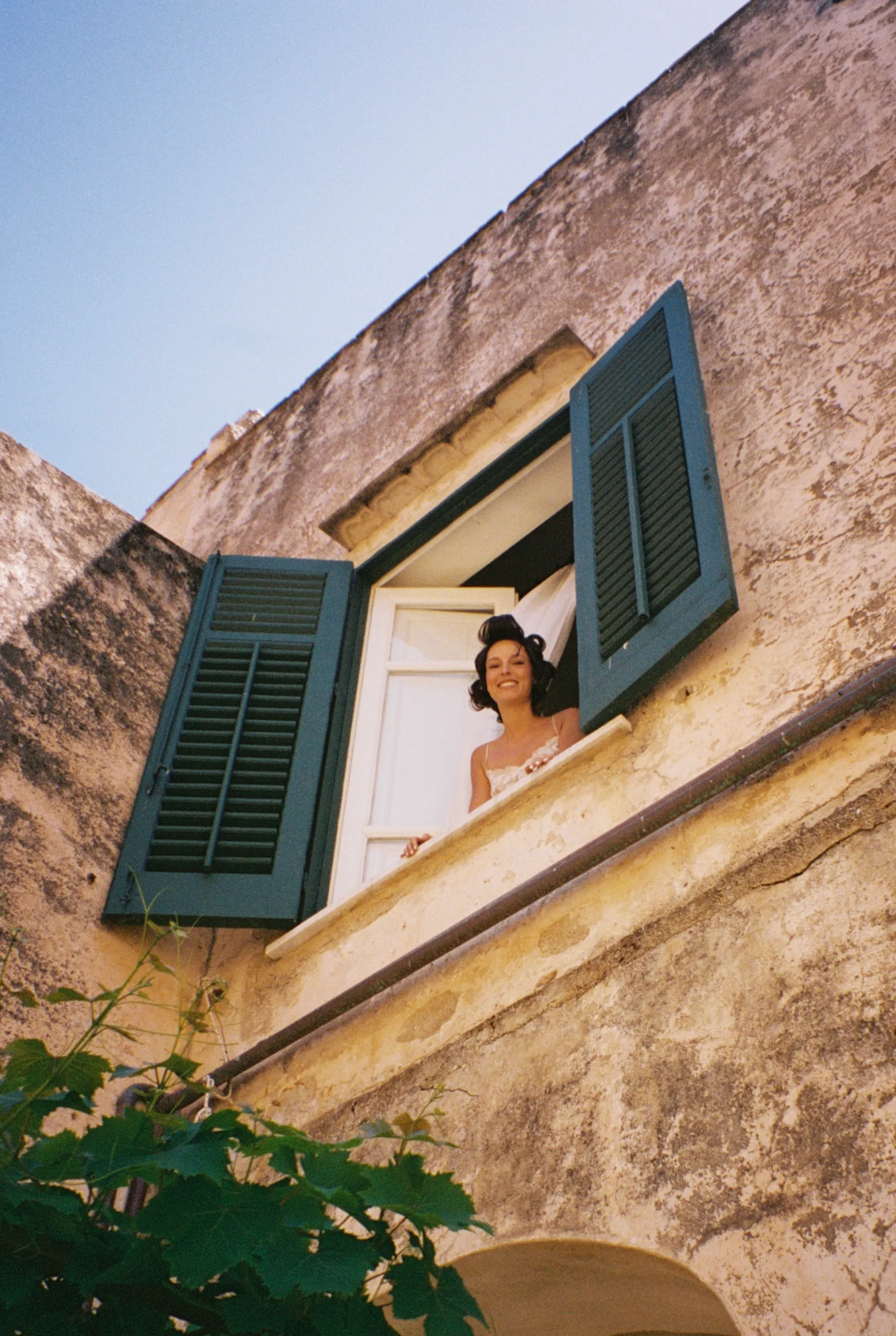 The bride in a window with green shutters