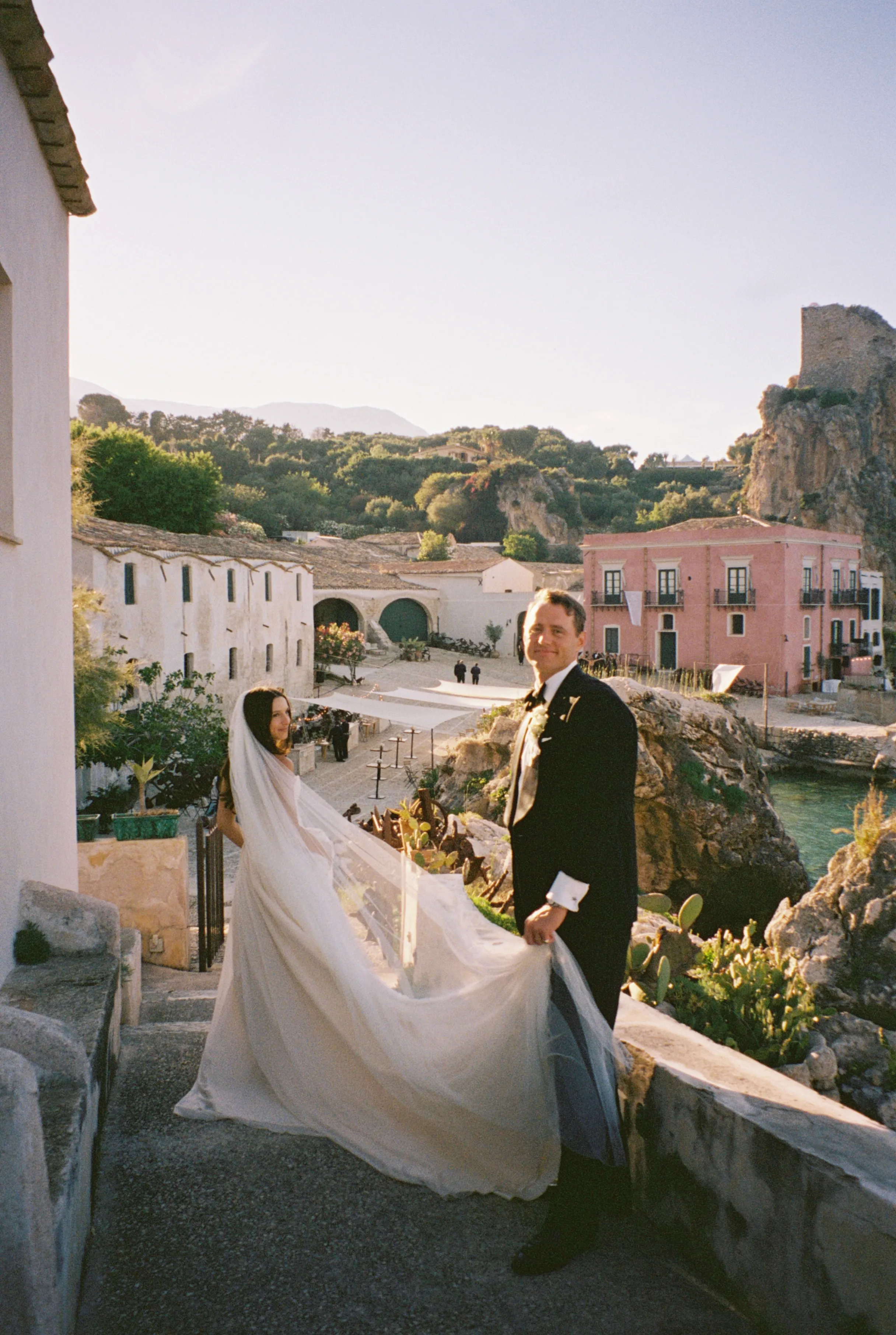 The couple on the steps with the villa behind